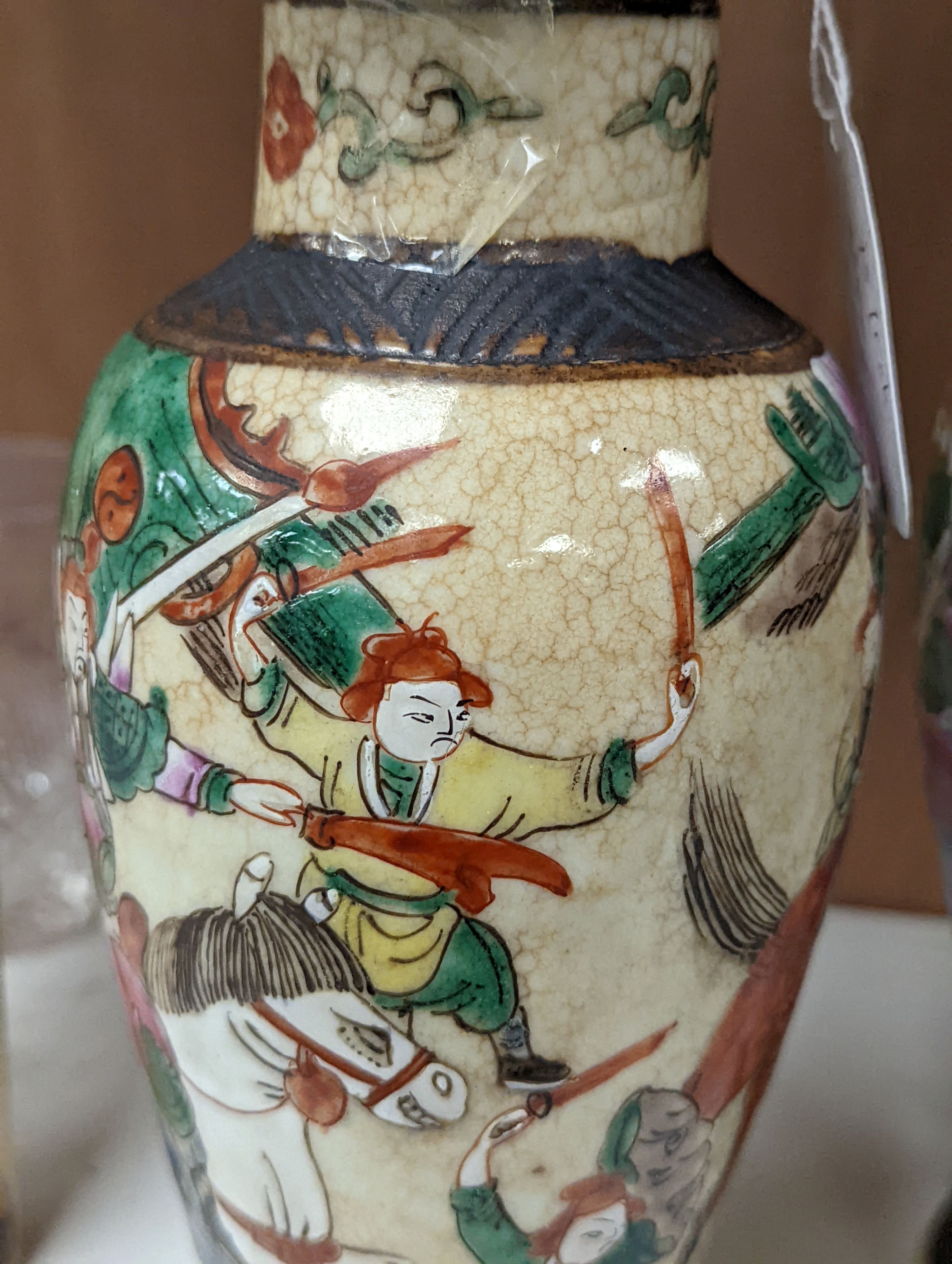 A pair of Chinese famille rose crackle glaze baluster jars and covers, 27cm.